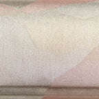 Close up detail of the surface of the vintage Japanese silk clutch bag, woven silver threads and pale pink in an abstract pattern.