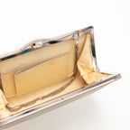 Inside view of the vintage Japanese kimono silk clutch bag showing cream silk lining and internal pocket edged in silver.
