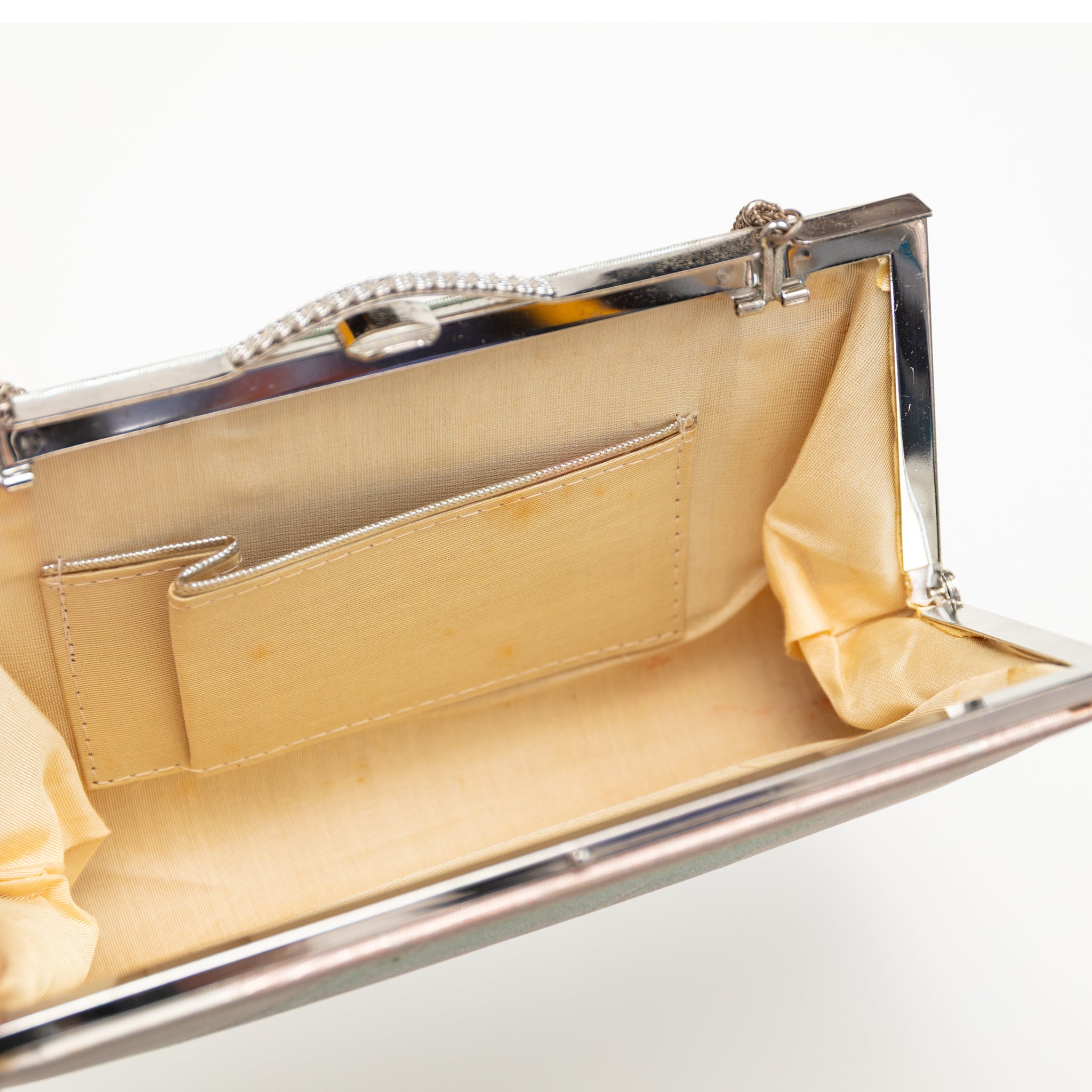 Inside view of vintage silk clutch bag from Kyoto showing cream silk lining and internal pocket.