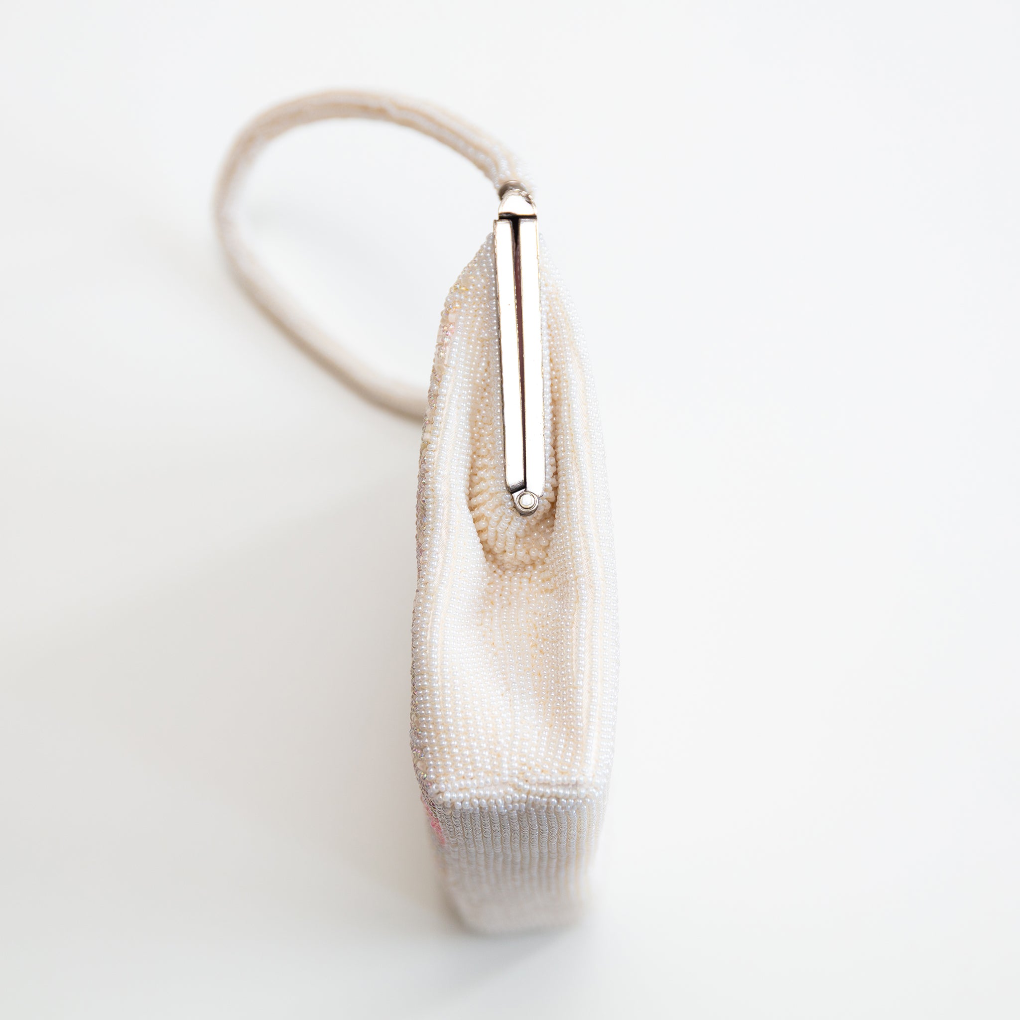 Side view of vintage Japanese beaded handbag showing structured shape and metal closure 