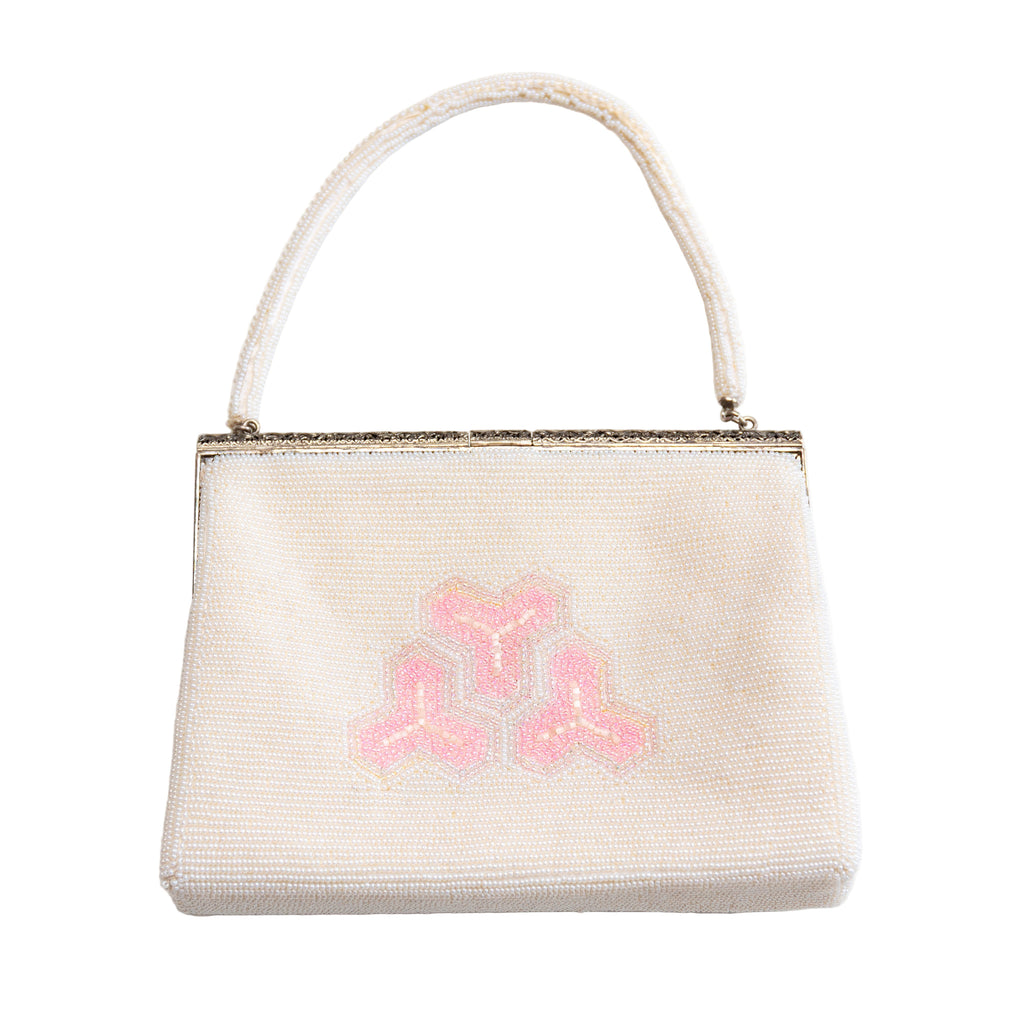Vintage Japanese beaded handbag with geometric design on white background, back view.