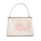 Vintage Japanese beaded handbag with geometric design on white background, back view.
