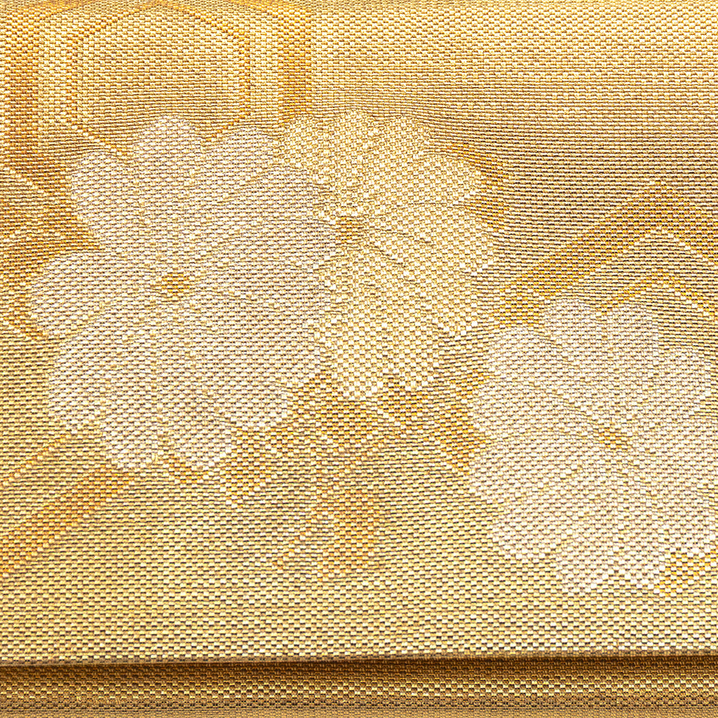 Close up of woven metallic gold silk flowers pattern on the front of a vintage Japanese silk clutch bag.