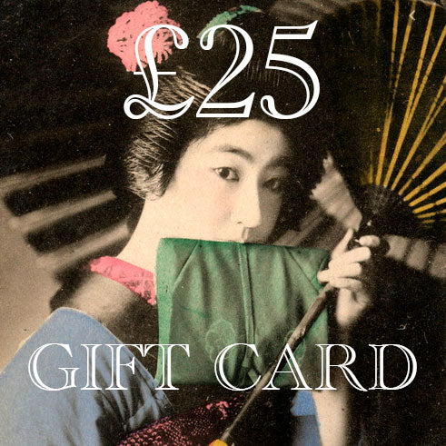 Close-up of the Hunted and Stuffed Gift Card with intricate embossed logo and textured metallic gold foil corner detail.