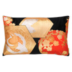 A rectangular cushion with a chinoiserie design featuring phoenix, plum blossom, and fortune hexagon patterns in black, gold, and orange colors, made from upcycled vintage Japanese silk.