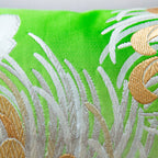 Gold and silver woven details over a bright green silk base, on a vintage kimono cushion.