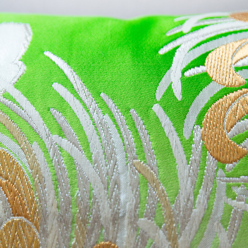Gold and silver woven details over a bright green silk base, on a vintage kimono cushion.