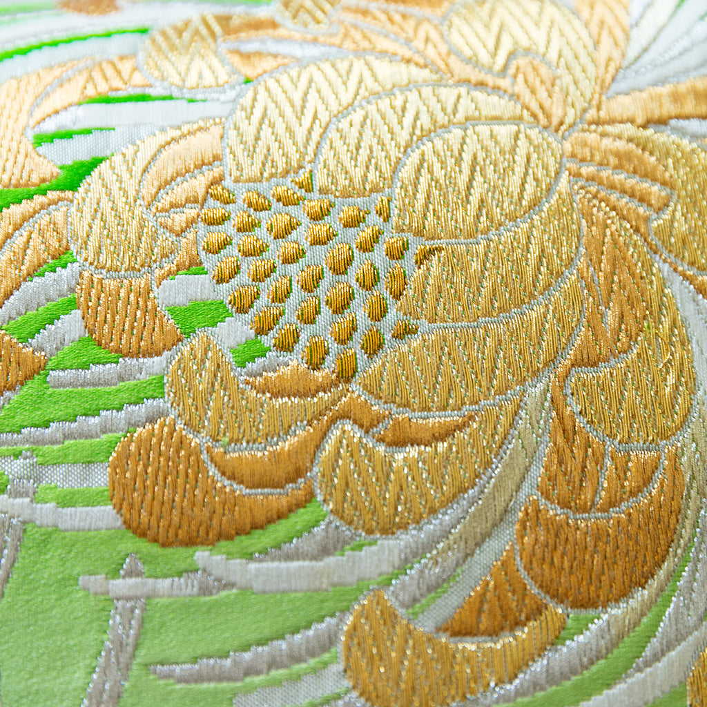 Gold kiku motif over silver and white tendrils on a green ombre silk base, vintage obi design detail.