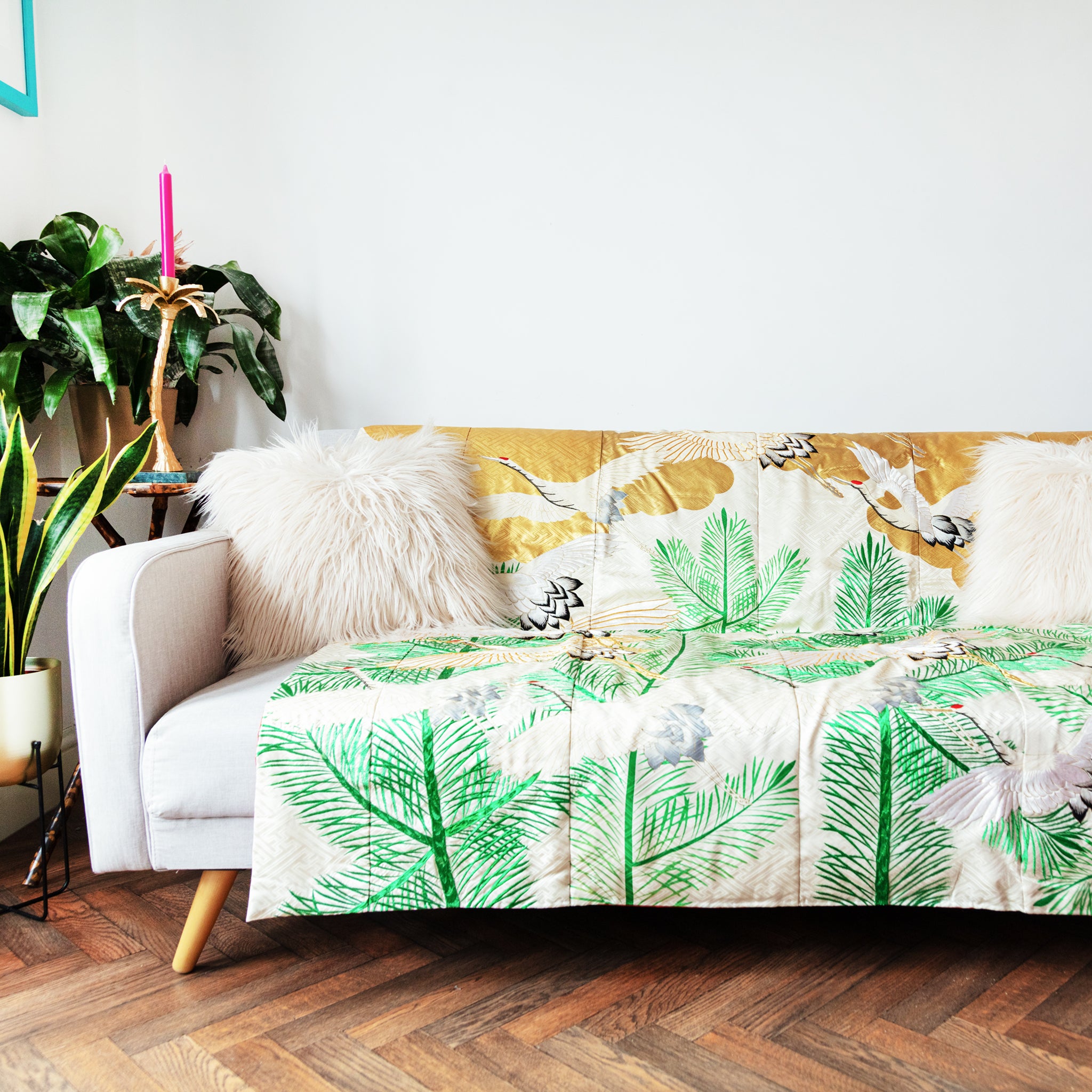 silk throw made from vintage kimono silk, cream base, green pines, gold clouds and cranes, on sofa
