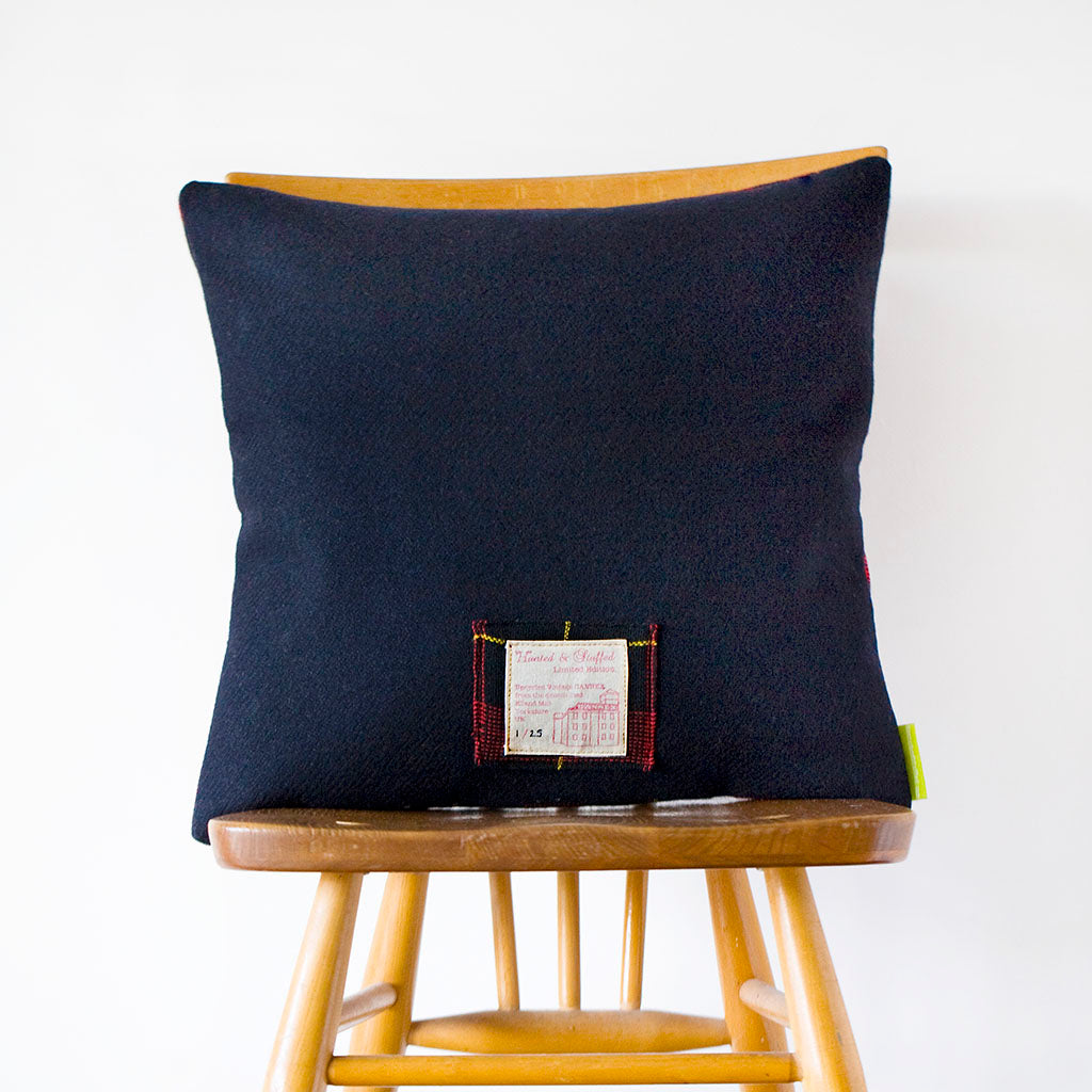 Close-up of navy wool tartan pattern highlighting vintage Gannex Ltd Ed branding and textured fabric detailing