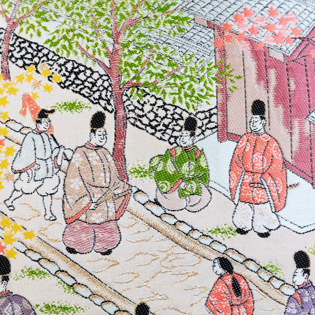 Close-up of embroidered obi silk depicting intricate street scene details with vibrant Nishijin craftsmanship.