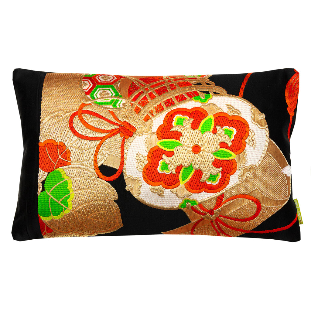 A rectangular cushion featuring a traditional Japanese black silk obi design with gold drum pattern and red accents.