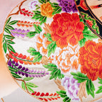 Close-up of the vibrant orange ombre silk fabric showcasing its smooth, lustrous texture and subtle silver bamboo pattern