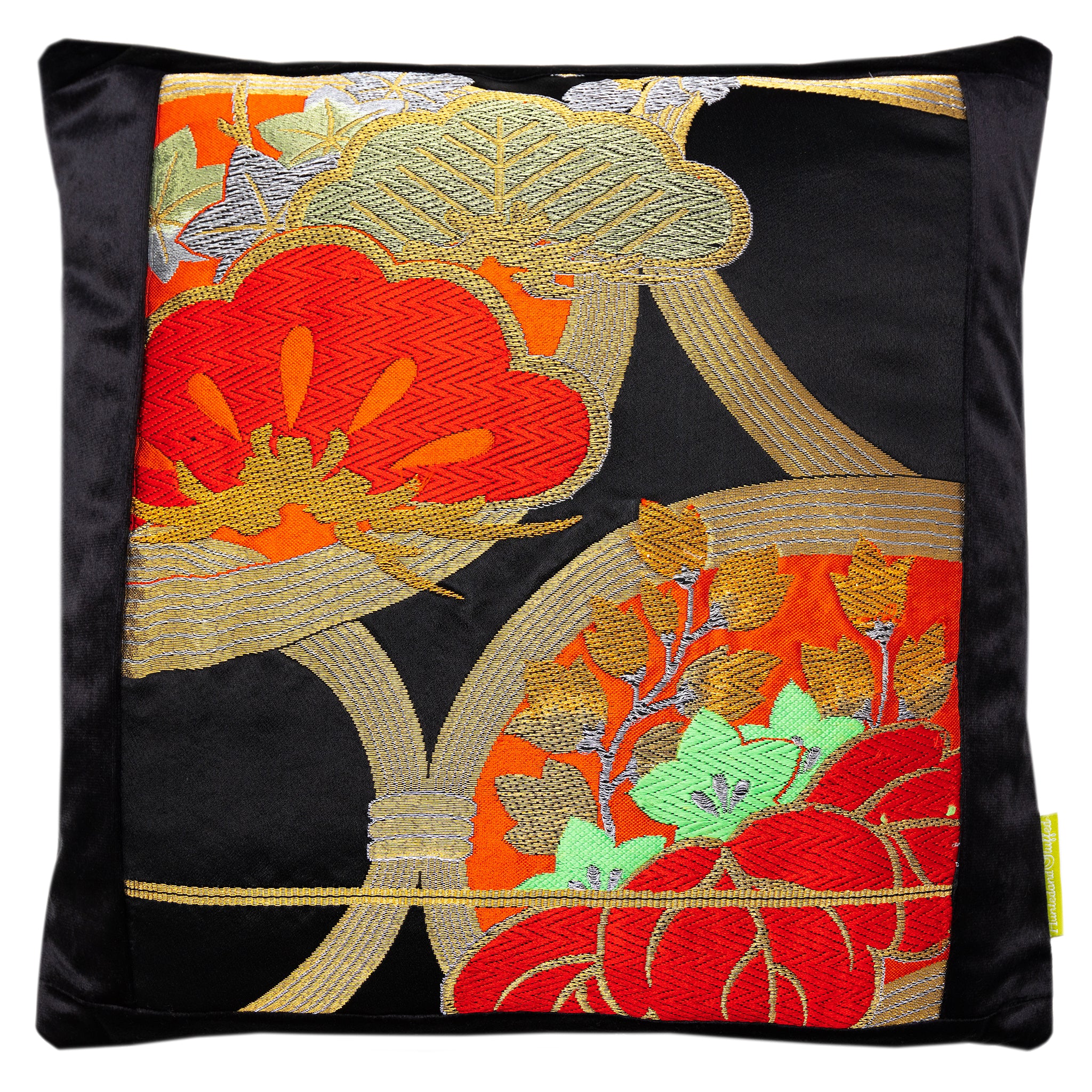 Close-up of red gold pine tree embroidery detail on the black velvet cushion fabric, highlighting rich texture and intricate