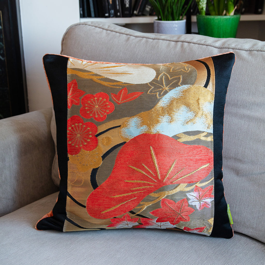 Close-up of peach velvet fabric highlighting its soft texture and subtle pines embroidery on the 16-inch Black Obi Pillow.