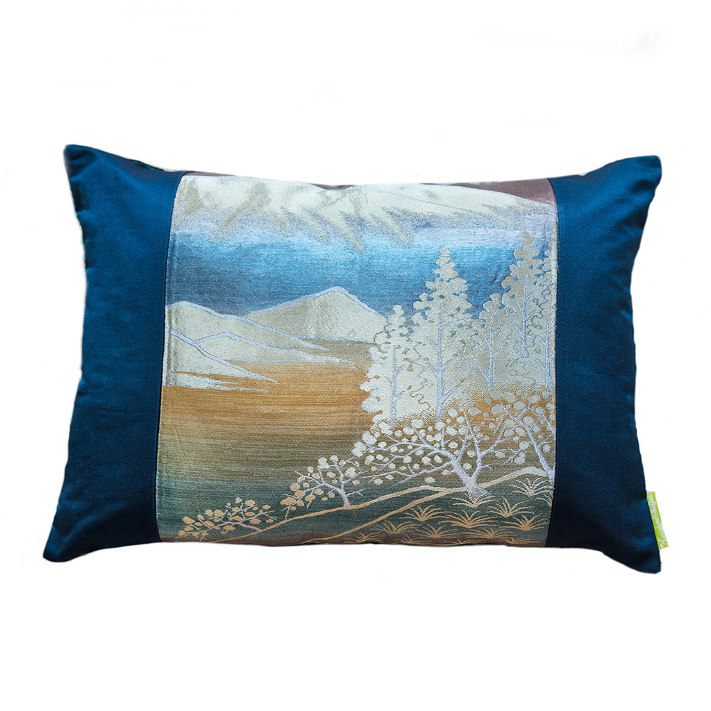 A blue silk and velvet cushion featuring a blue mountain scene with metallic gilt thread details. Upcycled vintage Japanese obi silk.