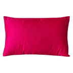 Reverse view of the rectangular silk cushion in bright pink silk on a white background.