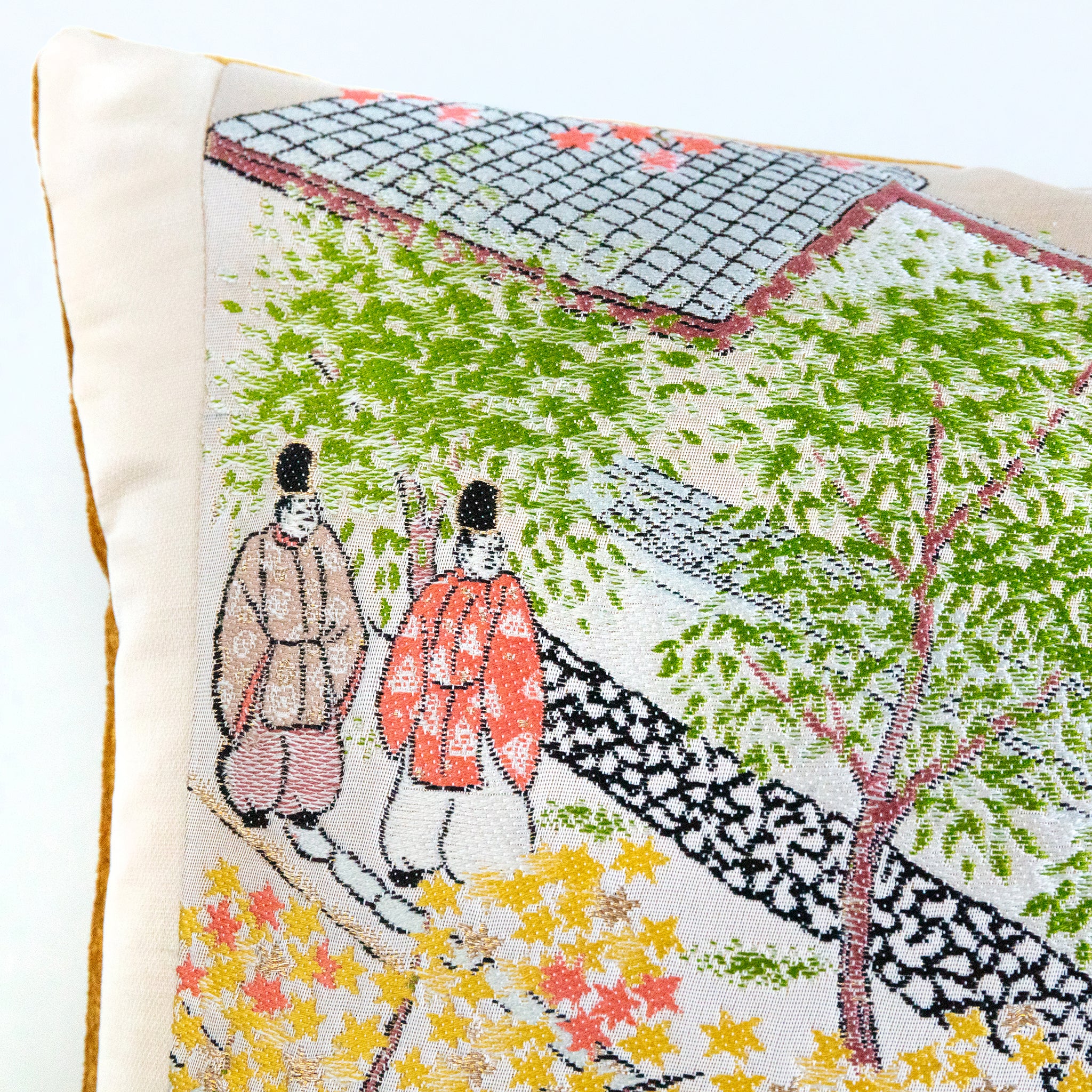 Close-up of vibrant Nishijin silk textile highlighting intricate woven floral patterns and rich color details on the Obi