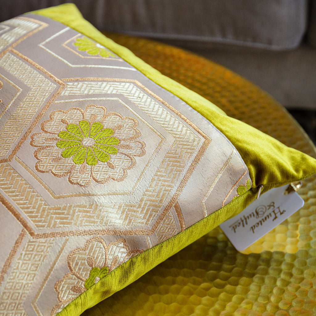 Close-up of the gold obi's textured silk weave with subtle chartreuse accents and intricate stitching detail.