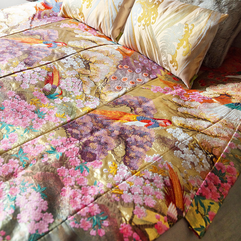 Detail shot of the vintage kimono-inspired silk throw blanket’s intricate floral embroidery and textured finish on soft