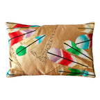 Rectangular metallic gold vintage silk obi cushion with colourful feather motifs on a white background.