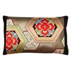 A rectangular Japanese obi silk cushion with a gold hexagon pattern on a black silk base, featuring vibrant geometric designs.