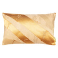 A rectangular cushion with a golden bamboo silk obi belt upcycled from a vintage Japanese garment, featuring metallic gold accents on butterscotch silk.
