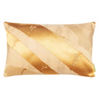 A rectangular cushion with a golden bamboo silk obi belt upcycled from a vintage Japanese garment, featuring metallic gold accents on butterscotch silk.
