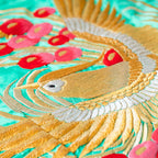 Close-up of intricate phoenix embroidery and shimmering gold silk fabric showcasing vintage wedding kimono-inspired quilting
