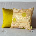 Close-up of gold geometric pattern and textured velvet surface on the Chartreuse Obi Pillow's side edge at a 45° angle.