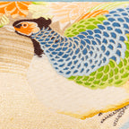 Close-up of cream Maru Obi silk embroidery detail on the pillow's corner, highlighting intricate stitching and luxurious