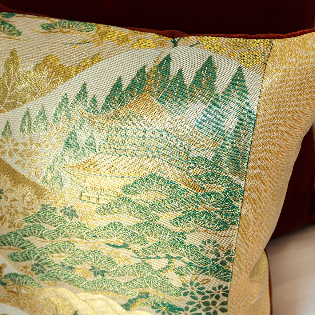 Close-up of the vibrant Nishijin kimono silk fabric featuring intricate mountain temple motifs with a velvet back edge and