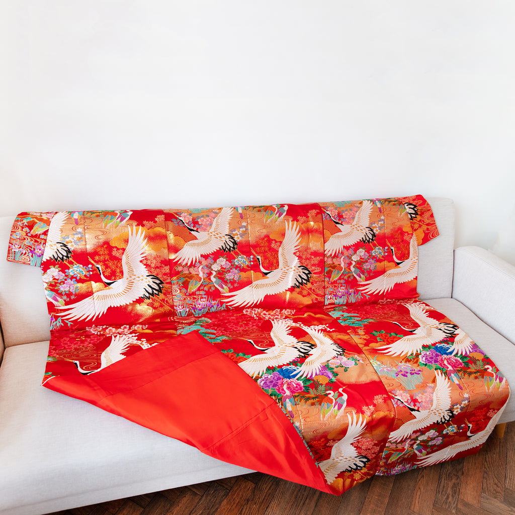 red silk vintage kimono throw on sofa with corner turned up to show red silk lining on reverse