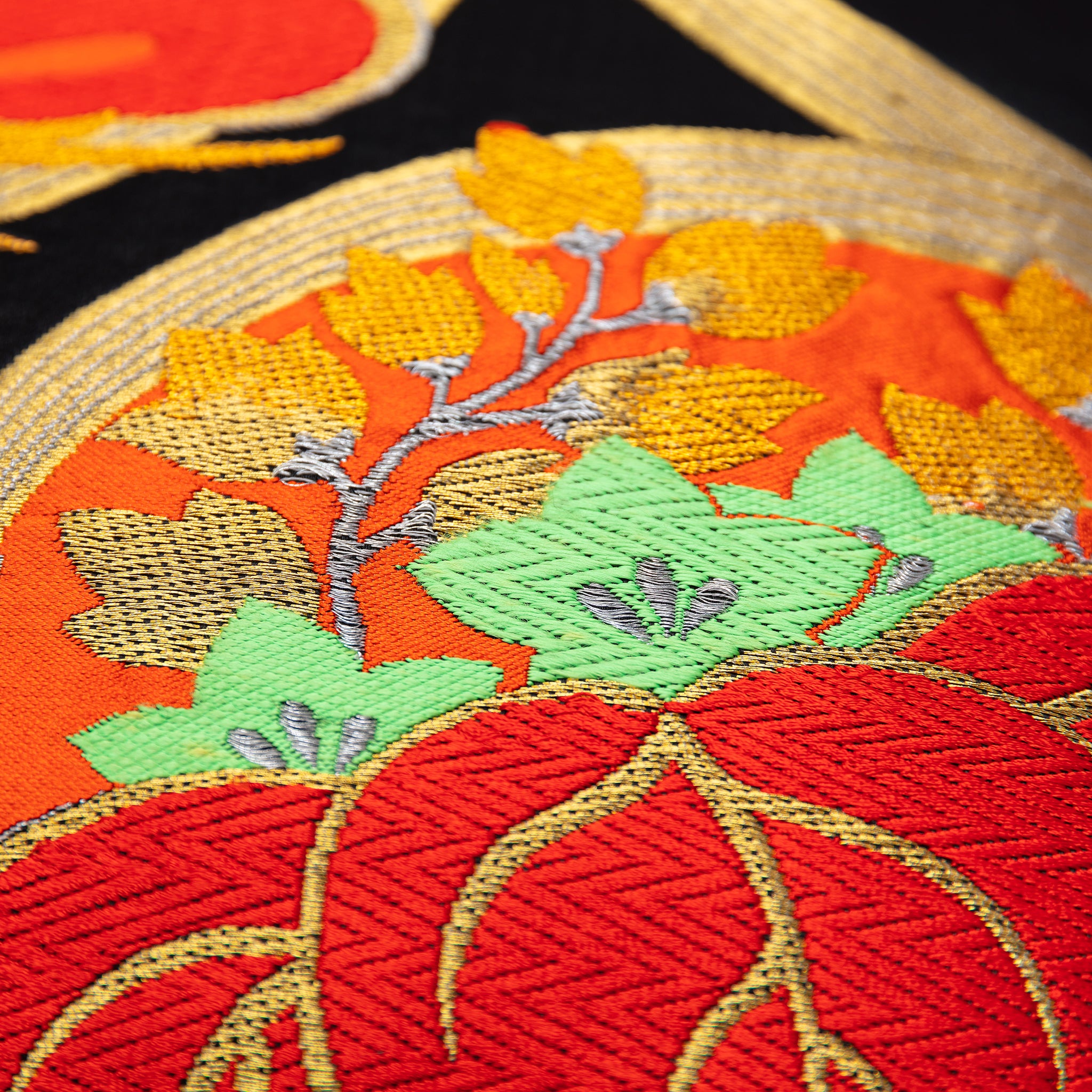 Close-up of the black velvet fabric showing soft texture and subtle sheen, highlighting the plush surface of the cushion's