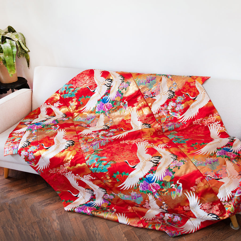 silk throw made from vintage kimono silk uchikake, multicolour flowers, white cranes on red draped on sofa
