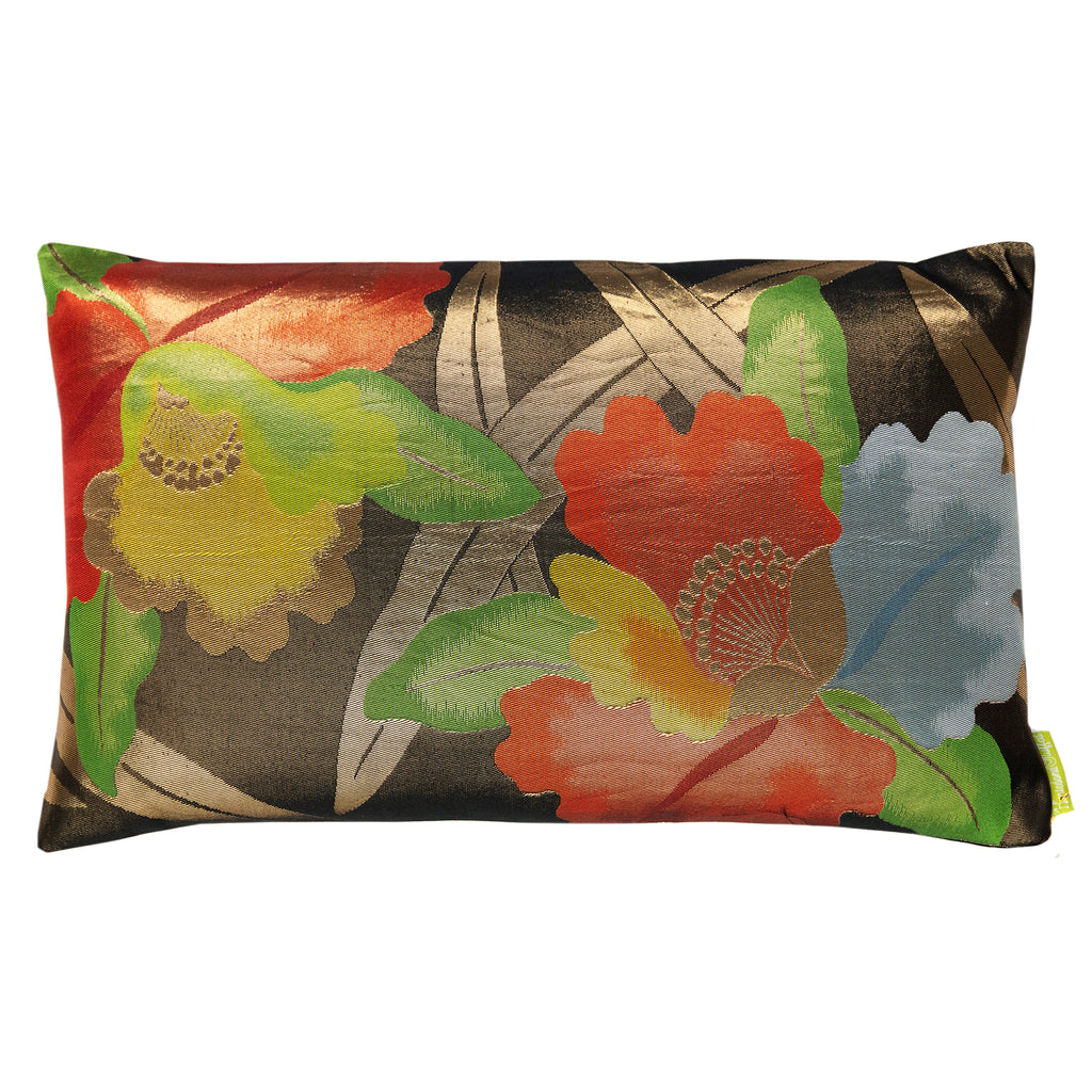 A rectangular throw pillow with a black, red, and yellow floral pattern on a silk base by Kimono Living.