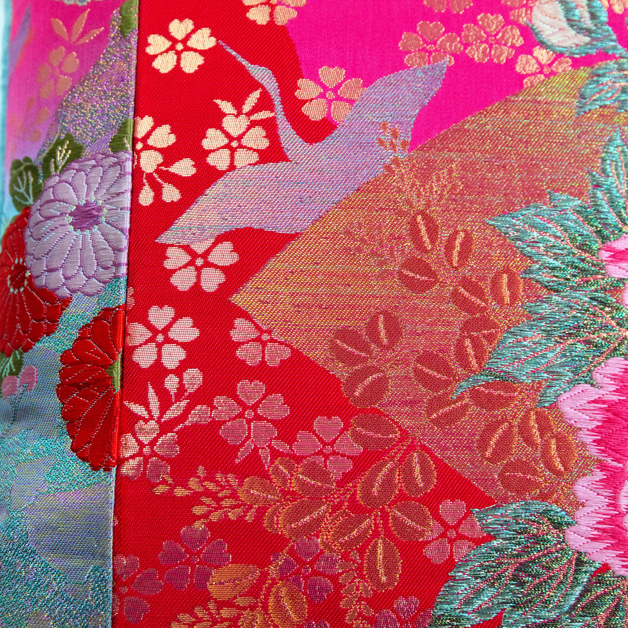 Close-up of the intricate pink crane embroidery on the velvet edge, highlighting fine stitching and rich color contrast.