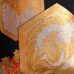 gold and silver crane motif in hexagon on black silk, detail of vintage Japanese obi pillow.