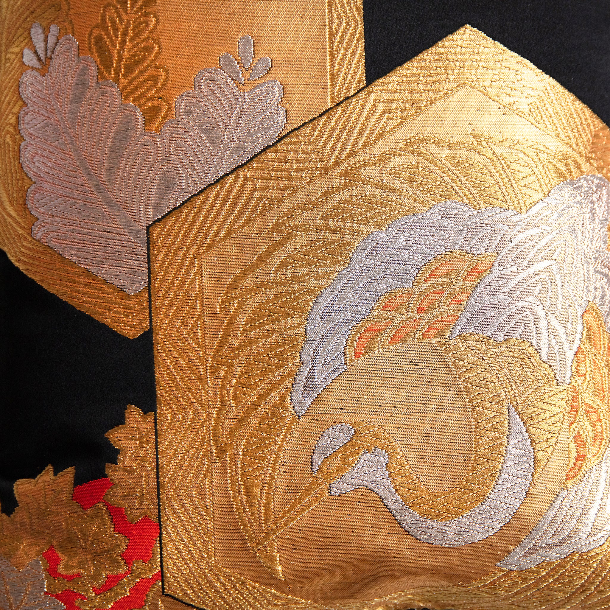 gold and silver crane motif in hexagon on black silk, detail of vintage Japanese obi pillow.