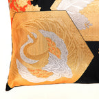 view of corner of black silk Japanese vintage obi pillow with gold and silver crane in fortune hexagon.