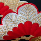 Close-up of the Black Silk Obi Pillow’s gold velvet embroidered pine branch detail, highlighting the textured stitching and