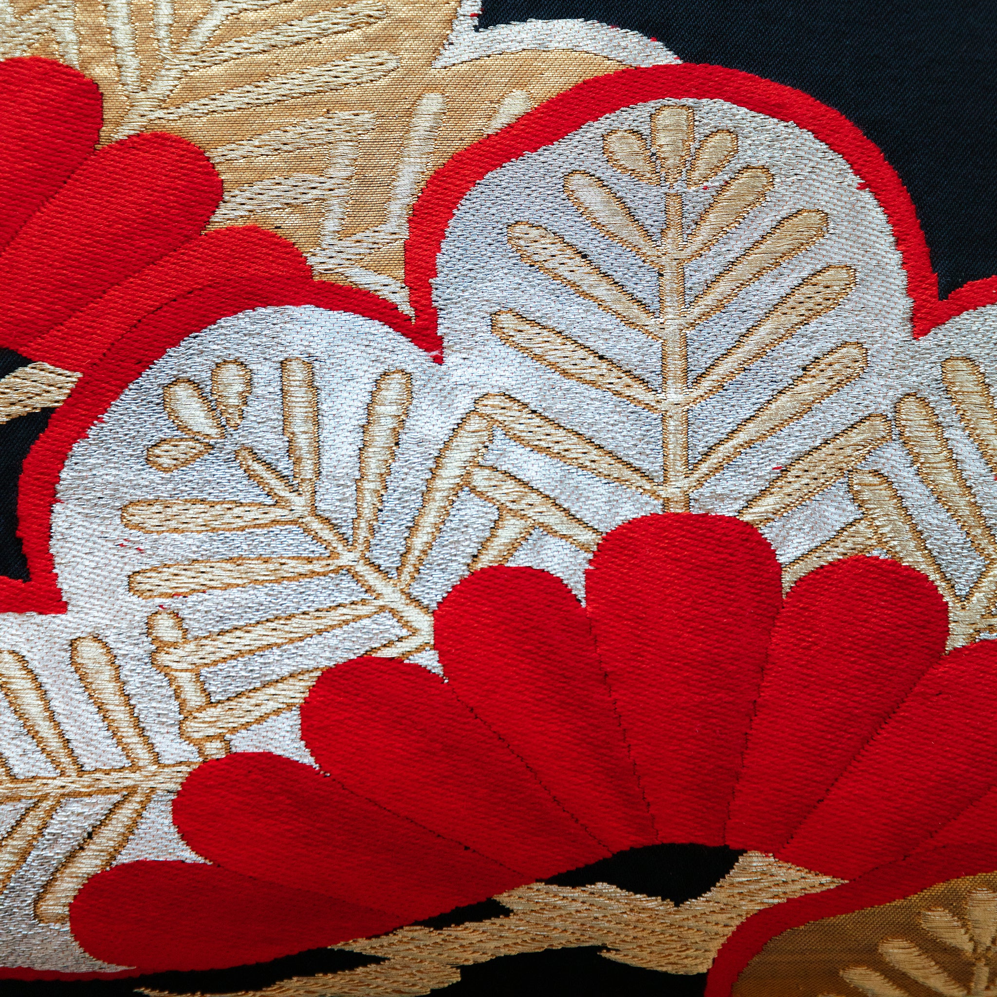 Close-up of the Black Silk Obi Pillow’s gold velvet embroidered pine branch detail, highlighting the textured stitching and