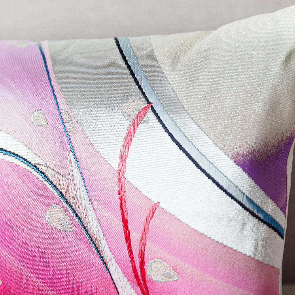 Close-up of the Peacock Pillow’s intricate pink and silver silk obi fabric showing textured weave and delicate embroidery