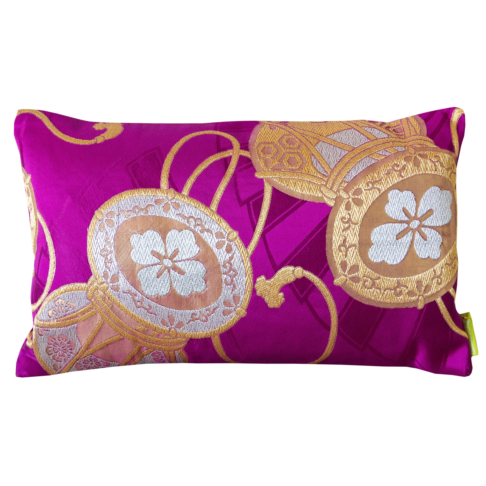 Purple silk cushion made from a vintage Japanese silk obi with gold and silver drum symbols. Rectangular in shape, on a white background.