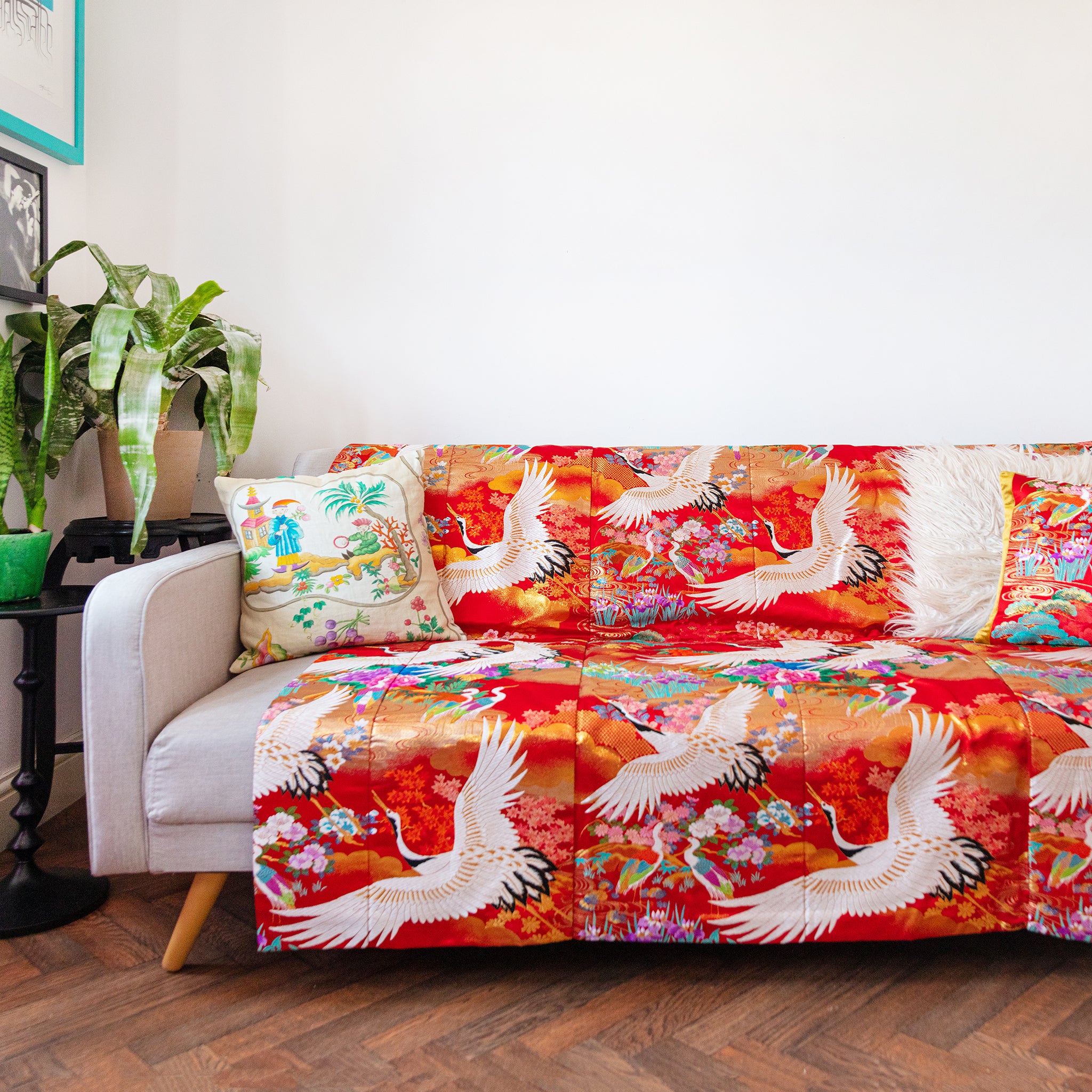 silk throw in vintage kimono silk with cranes and floral pattern in red over a sofa