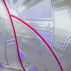 Close up detail of silver woven genji wheels with bright pink accent over purple ombre silk, from a vintage Japanese obi cushion.