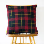 Close-up of grey tartan Wool Cushion cover’s woven texture and subtle color variations from a diagonal angle.