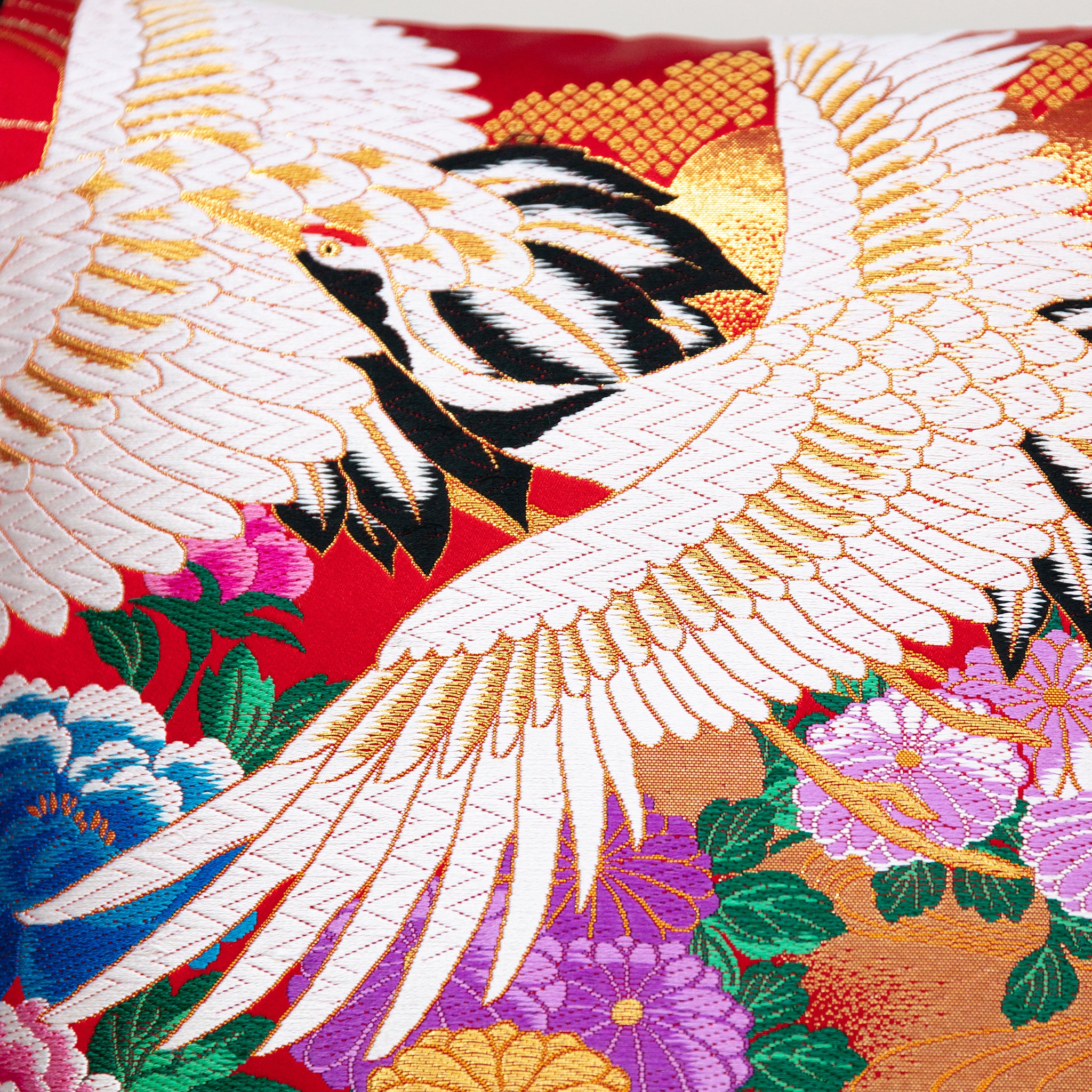 Close-up of red silk embroidery detailing on the black velvet surface of the 16-inch Wedding Uchikake cushion, highlighting