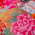 Close-up of pink velvet and silk detailing on the flying crane embroidery, highlighting intricate stitching and textured