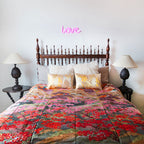 Close-up of vintage floral embroidery details on the silk throw blanket’s edge, highlighting intricate stitching and